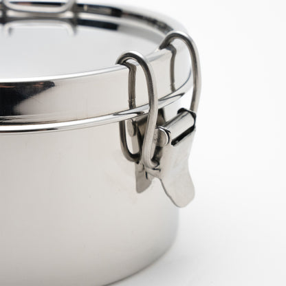 close up of a stainless steel clamp of a lunch box