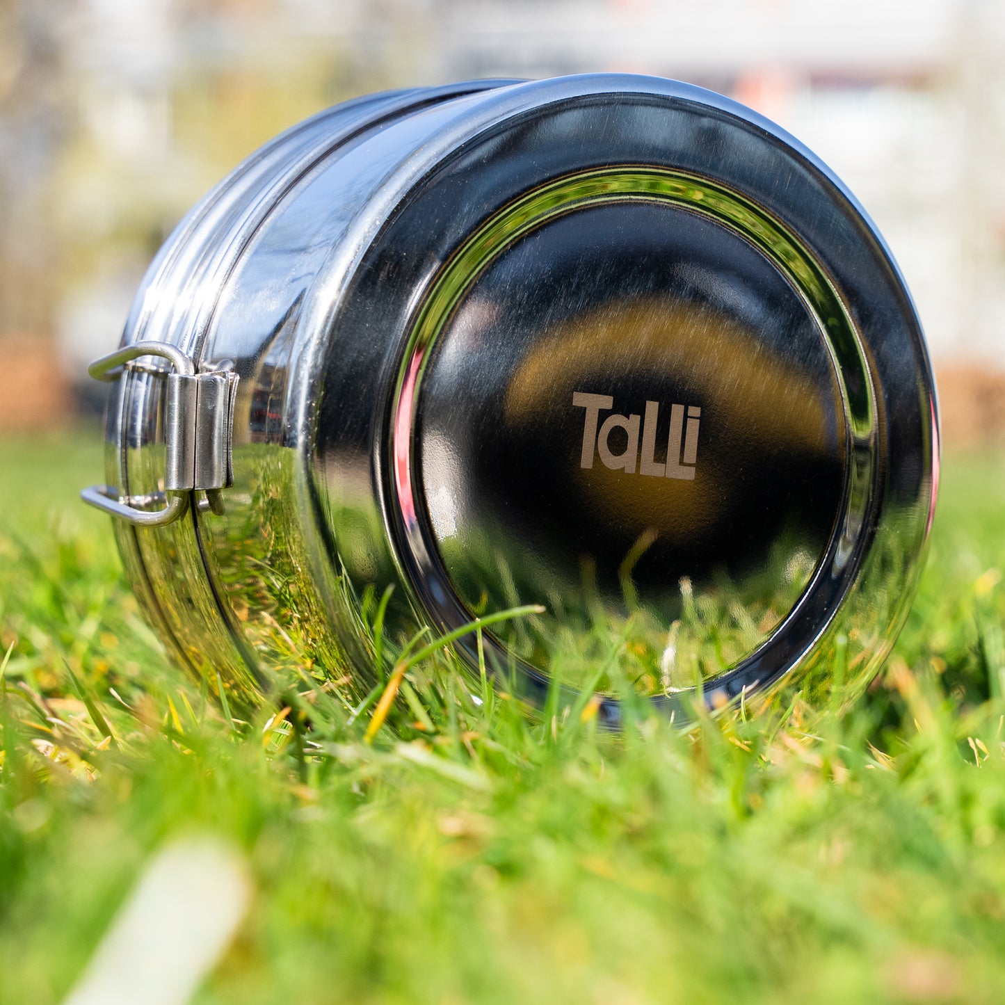 Talli logo on the back of a stainless steel lunch box