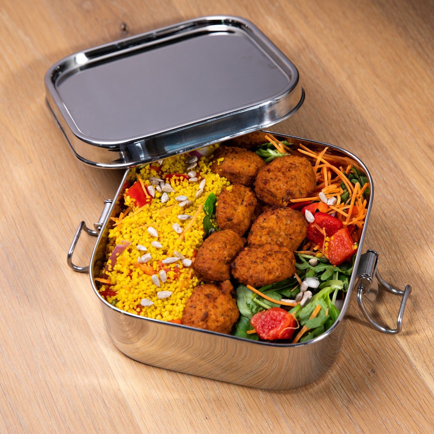 Leakproof stainless steel lunch box filled with a meal salad