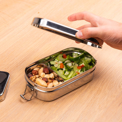 Stainless steel lunch box with snack box filled with nuts and salad