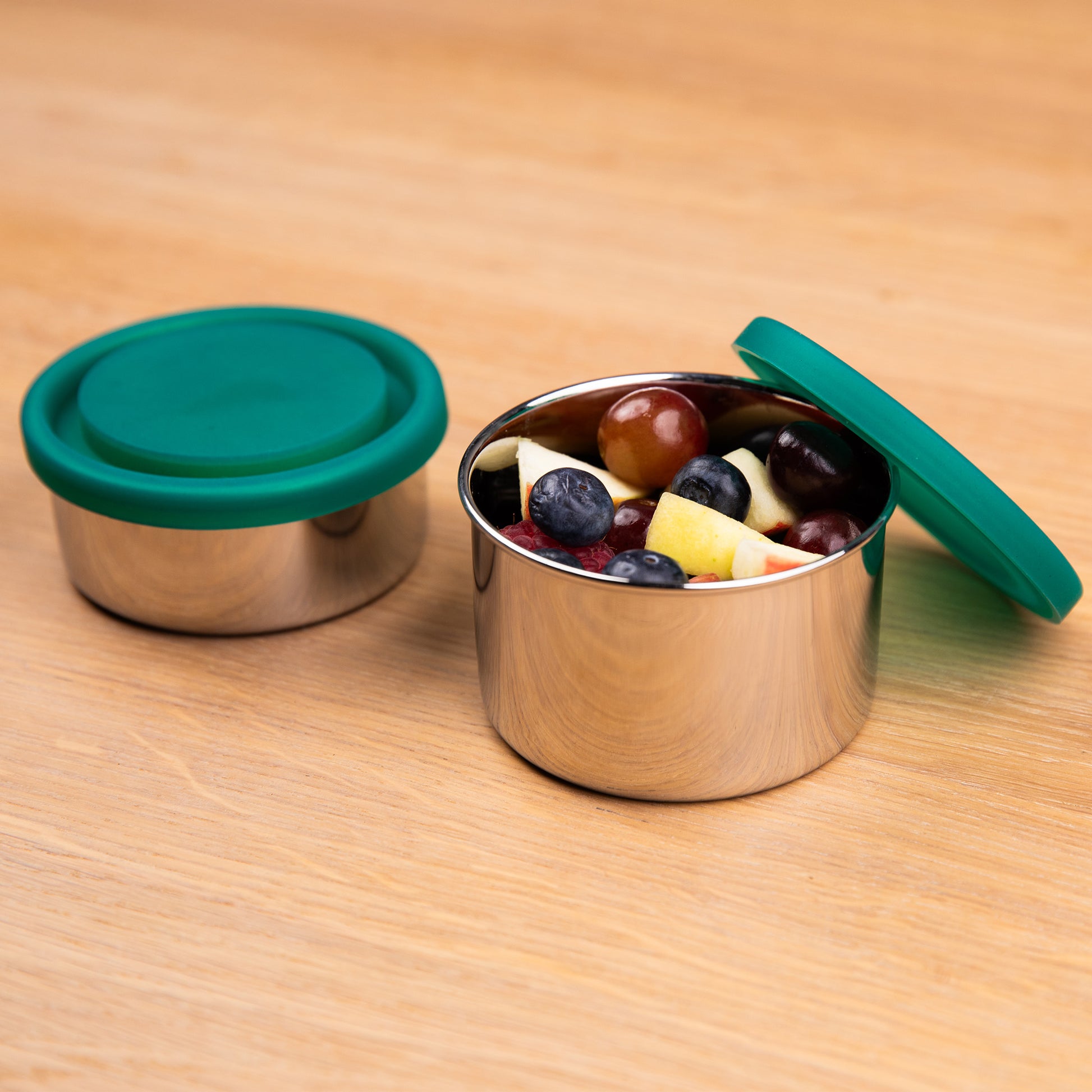 Stainless steel fruit bowl filled with fruit and leak-proof lid