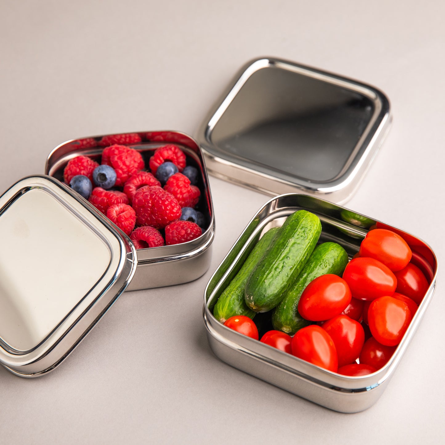 Stainless steel fruit containers filled with vegetables and fruit