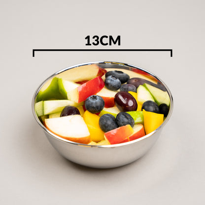 Fruit bowl filled with fruit on white
