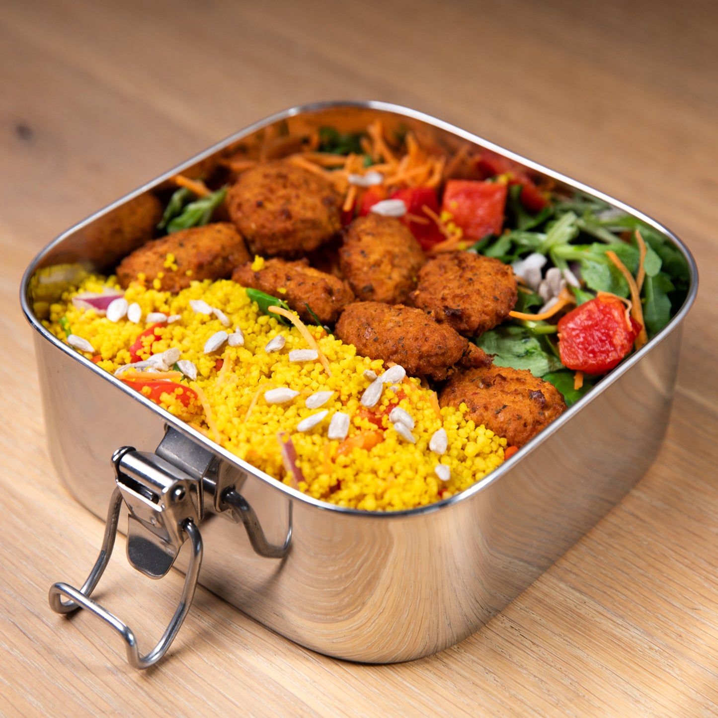 Stainless steel leak-proof lunch box filled with a falafel salad.