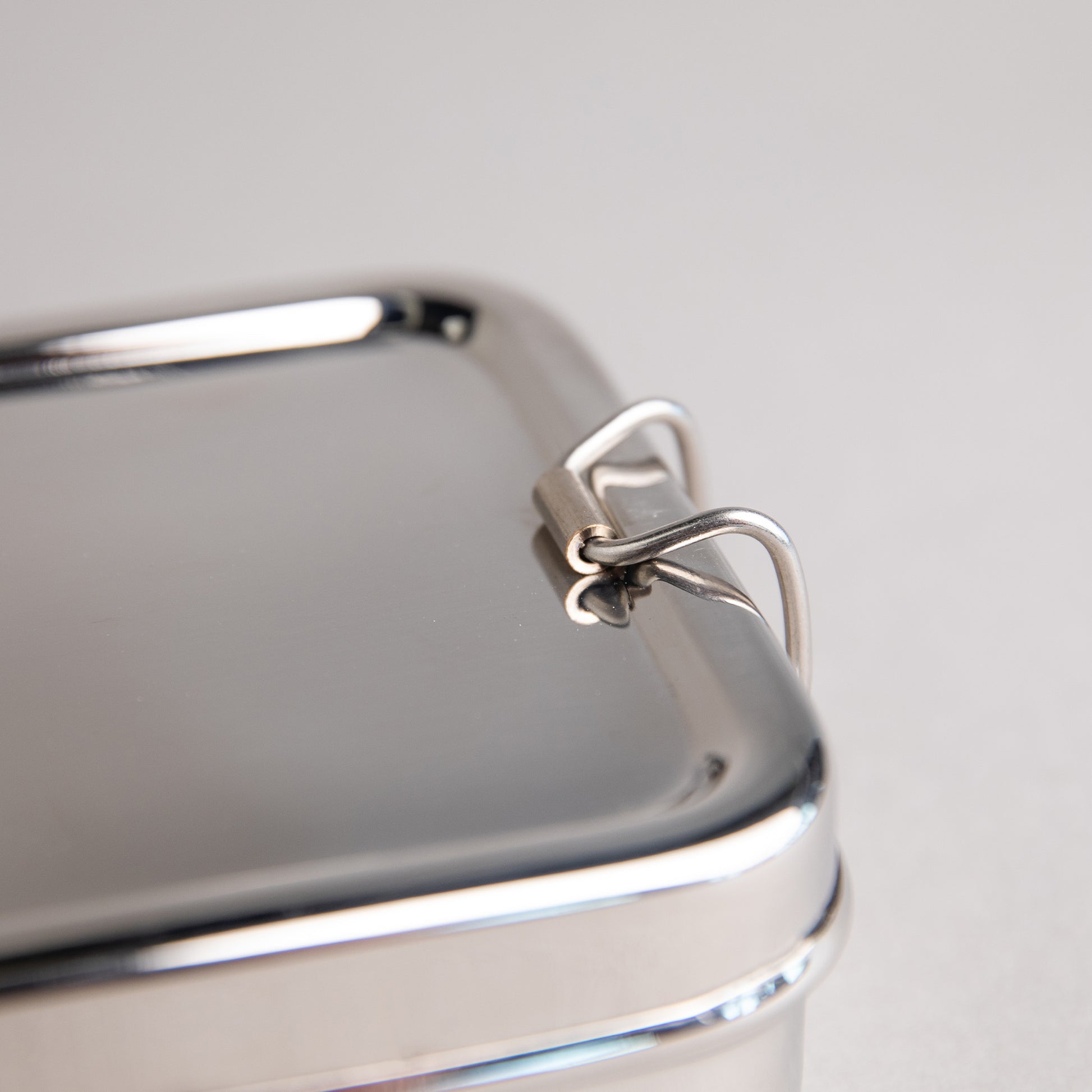 close up of a stainless steel clip of a lunch box