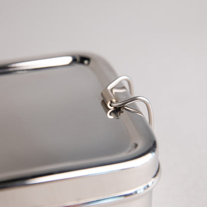 close up of a stainless steel clip of a lunch box