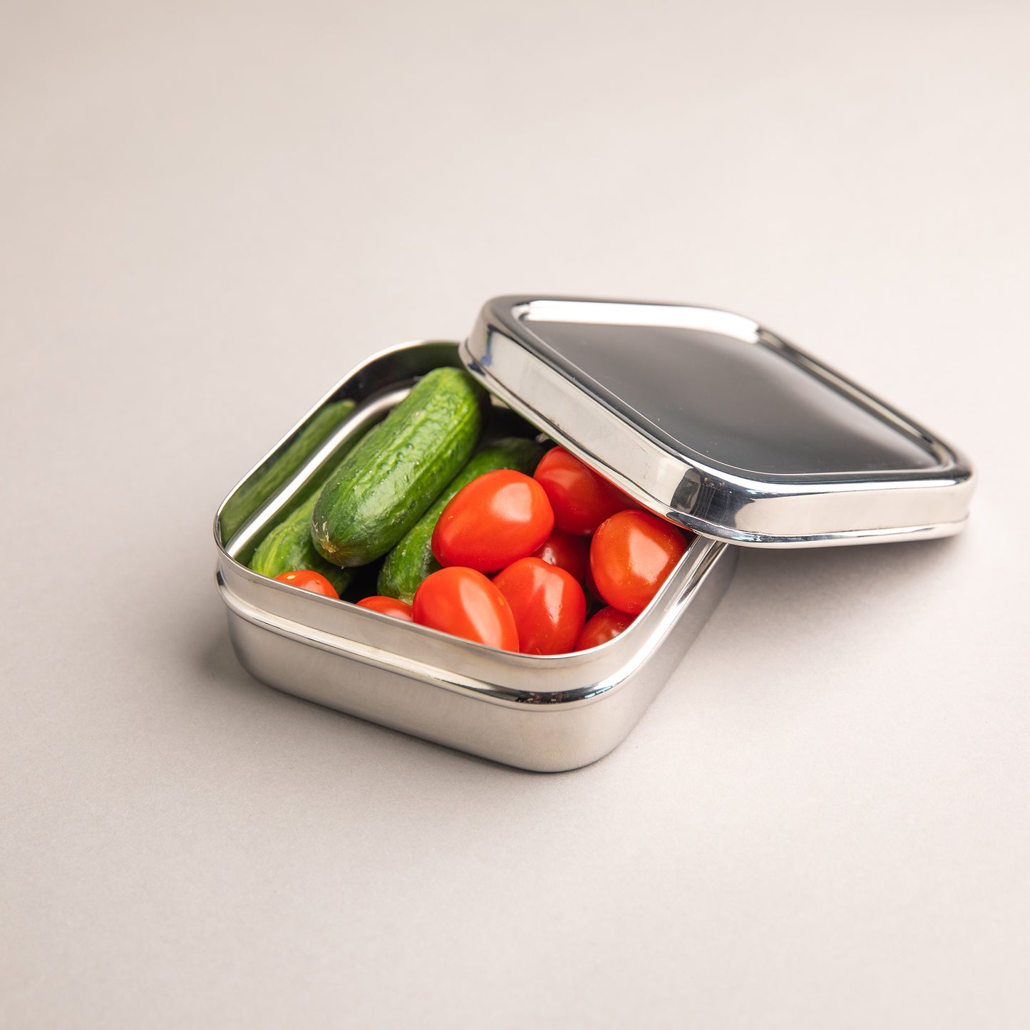 Stainless steel snack box filled with cucumber and tomato