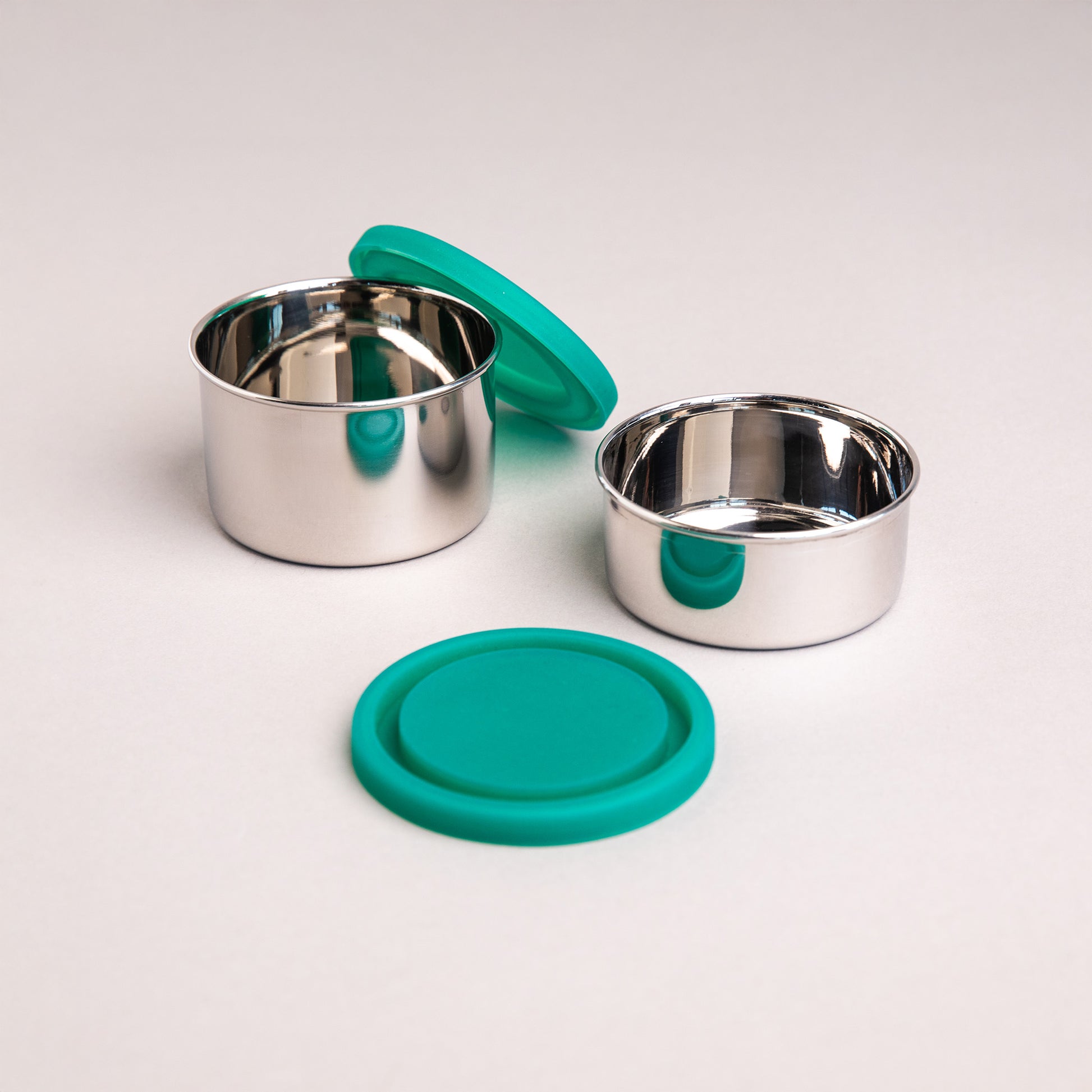 two stainless steel snack boxes with silicone lids
