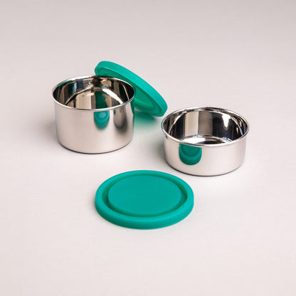 two stainless steel snack boxes with silicone lids