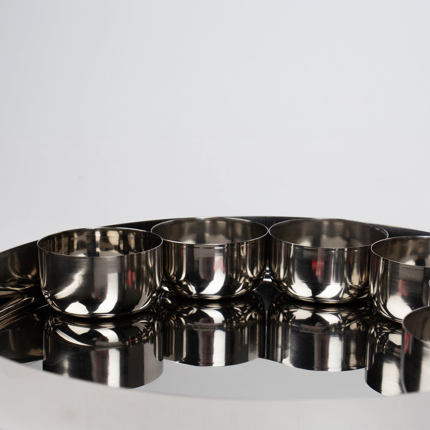 close up of 4 bowls on a thali plate 