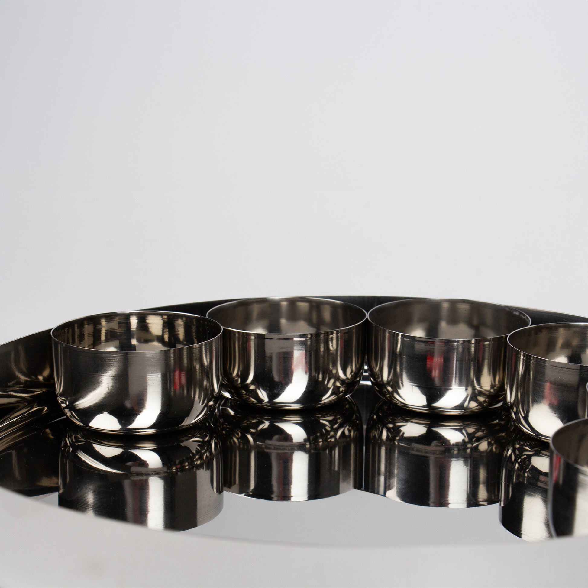 close up of 4 bowls on a thali plate 