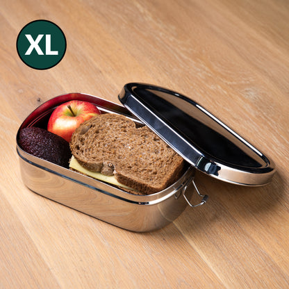 Stainless steel lunch box filled with sandwiches and fruit