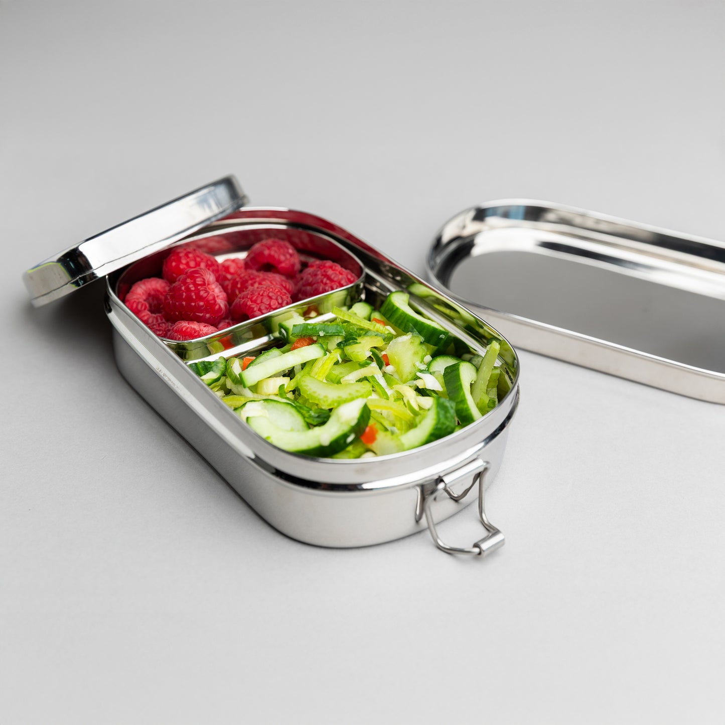 Stainless steel bento lunch box with compartments for children opened, with two lids