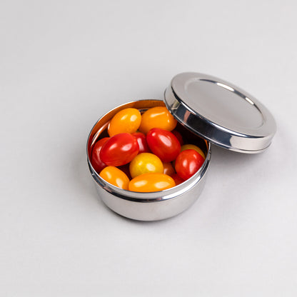 Large stainless steel snack box filled with tomatoes