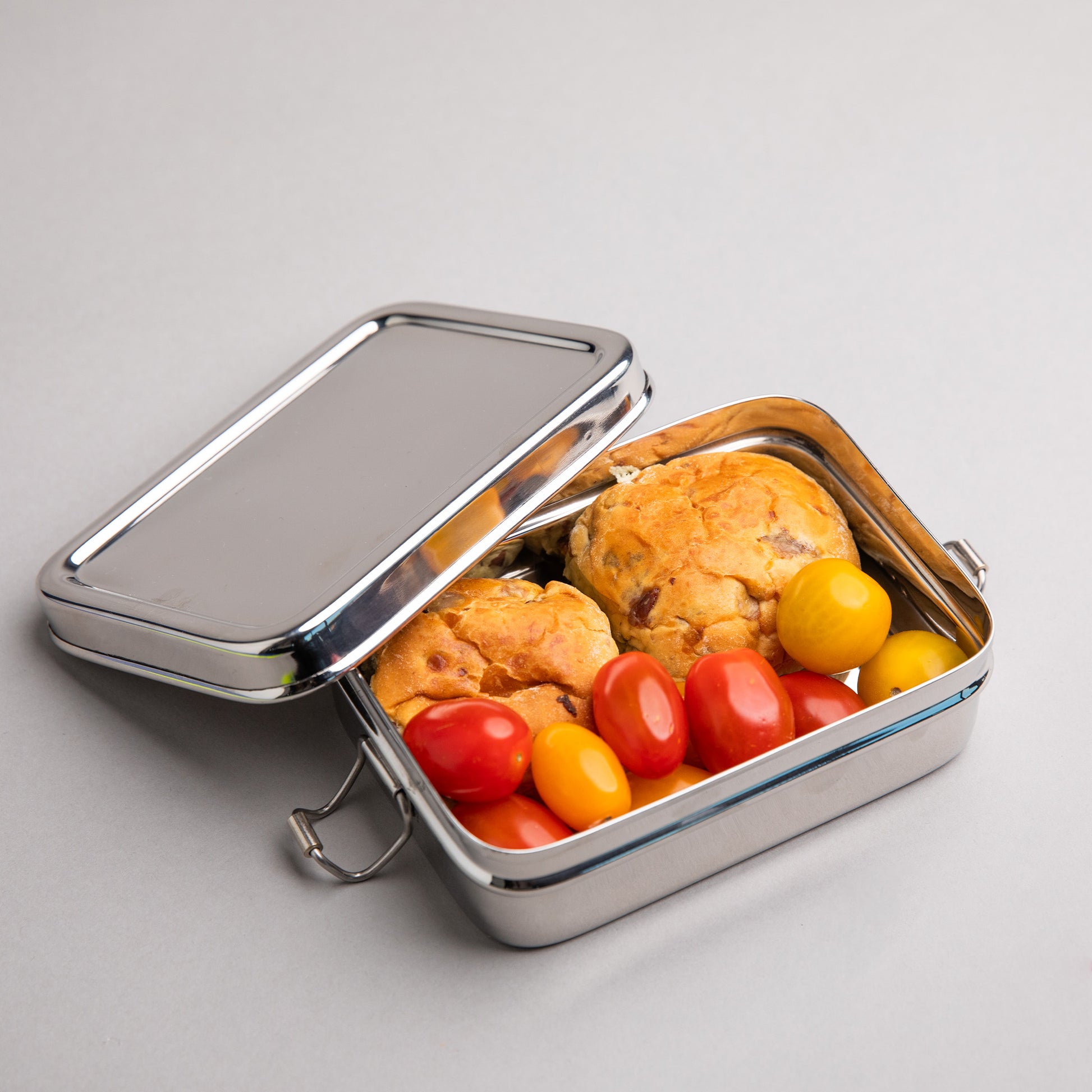 Stainless steel lunch box half opened filled with lunch