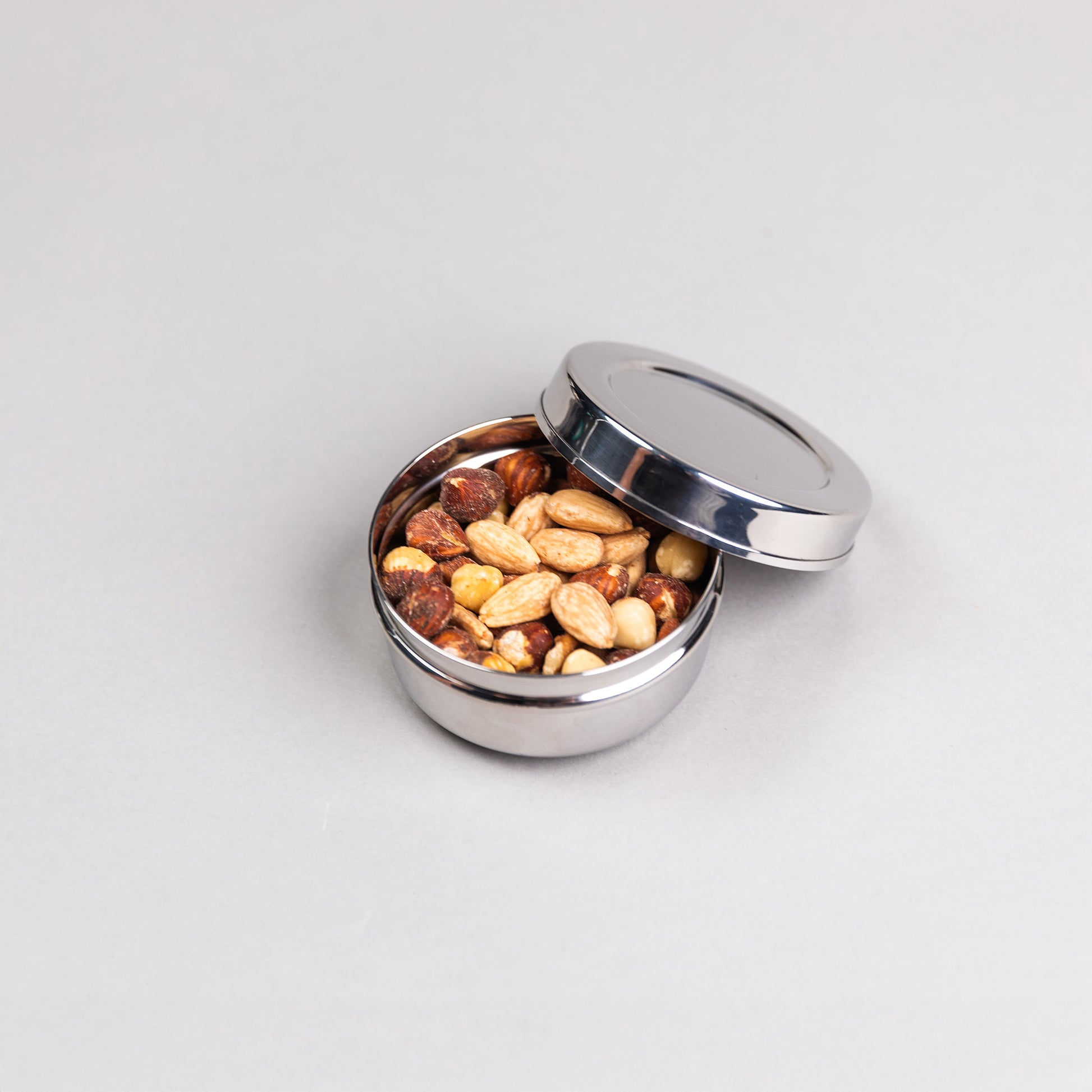 1 round stainless steel snack box filled with nuts