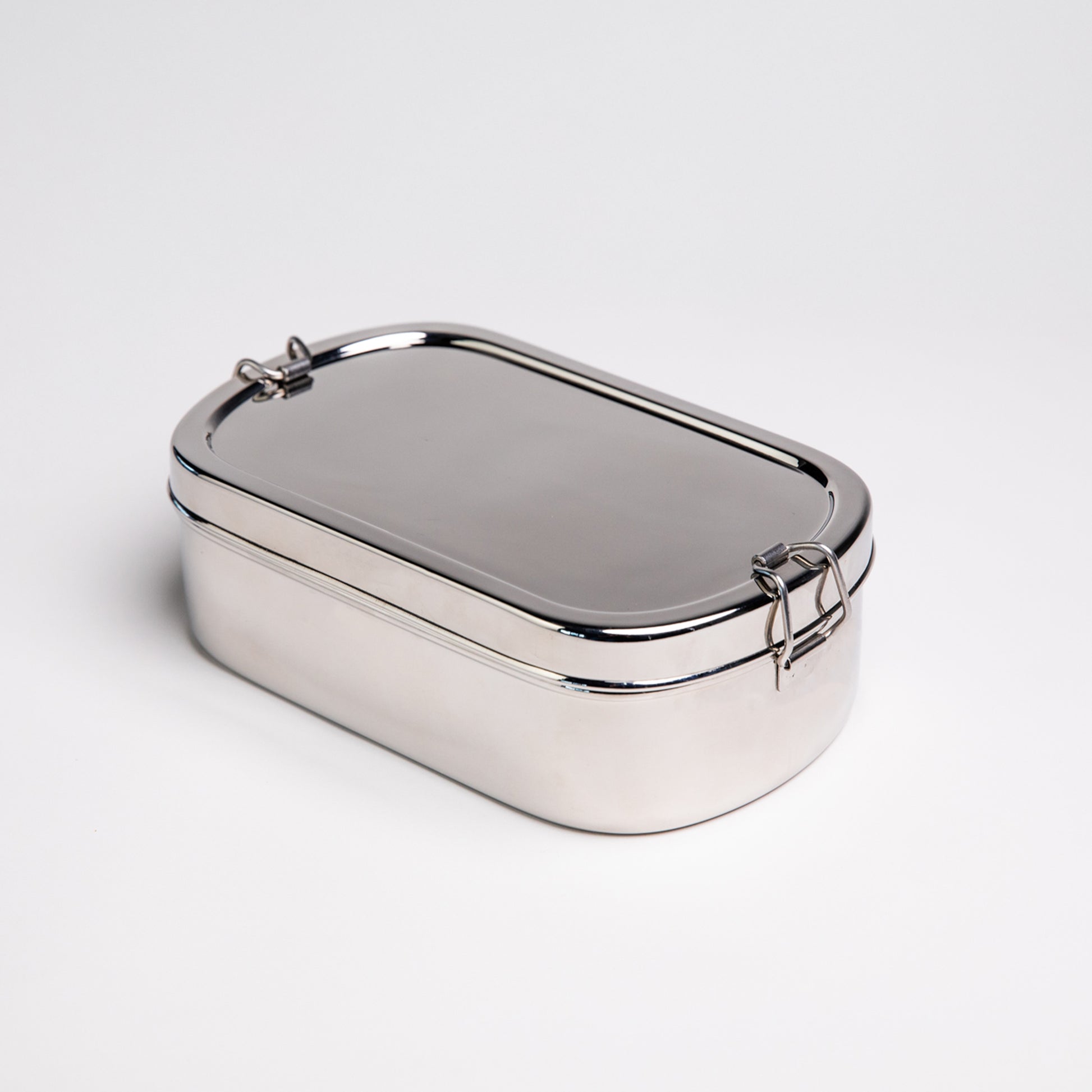 Stainless steel lunch box closed on a white background 