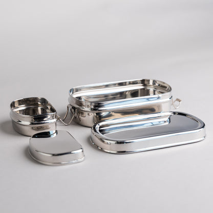 Stainless steel lunch box with snack box opened on gray background