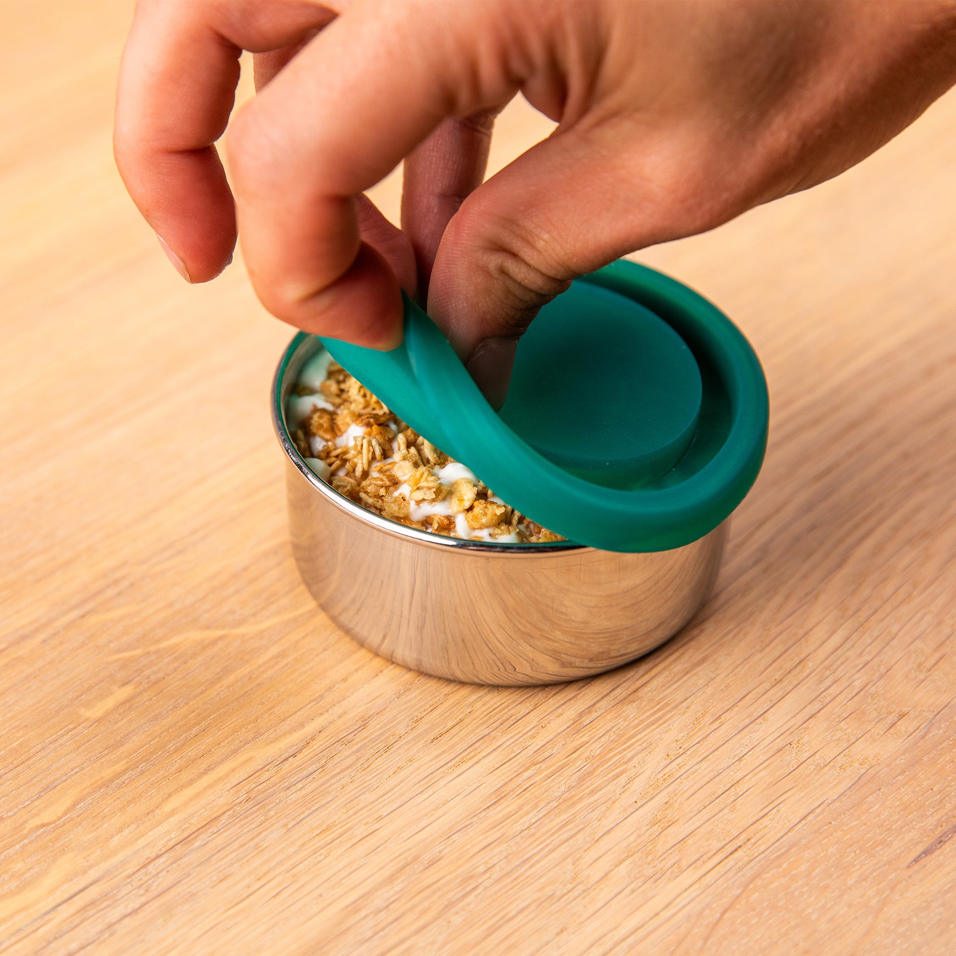 Stainless steel snack box with silicone lid. filled with yogurt.