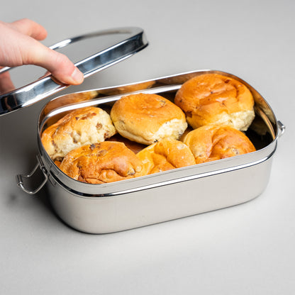 Stainless steel lunch box filled with currant buns